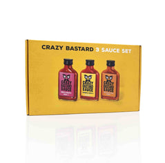Coffret Crazy Bastard Sauce piquante avec trois bouteilles : Mango & Ghost Pepper, Tomatillo & Habanero, Pineapple & Chipotle.